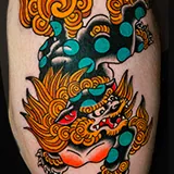 Japanese-style tattoo of a Karajishi, a guardian lion-dog figure often referred to as a Foo Dog, with aqua spots and flowing golden hair, crafted by Shannon Hodgkin at House of Wolves Tattoo, Geelong