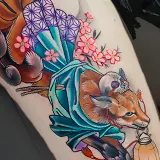Neo-Traditional leg tattoo of a six-tailed Kitsune fox wearing a flowing teal kimono and holding a lantern in its mouth, framed by pink cherry blossoms, designed by Lacey Griffiths at House of Wolves Tattoo, Geelong