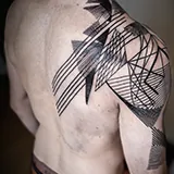 Abstract black linework tattoo wrapping around and over the shoulder, designed by Mark Noel at House of Wolves Tattoo, Geelong