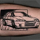 Classic Nissan Skyline drifting and breaking through its surrounding frame in a fine-line tattoo rendered with extreme precision, designed by Scott Russell at House of Wolves Tattoo, Geelong