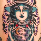 American Traditional tattoo of a green-skinned witch with a crystal ball, created by Joshua Reynolds at House of Wolves Tattoo, Geelong