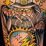 American Traditional tattoo of a wizard casting a spell over a flaming crystal ball, crafted by Shannon Hodgkin at House of Wolves Tattoo, Geelong